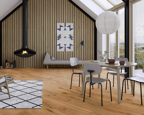 contemprory looking living room with fire place and dining table showing boen wooden flooring.